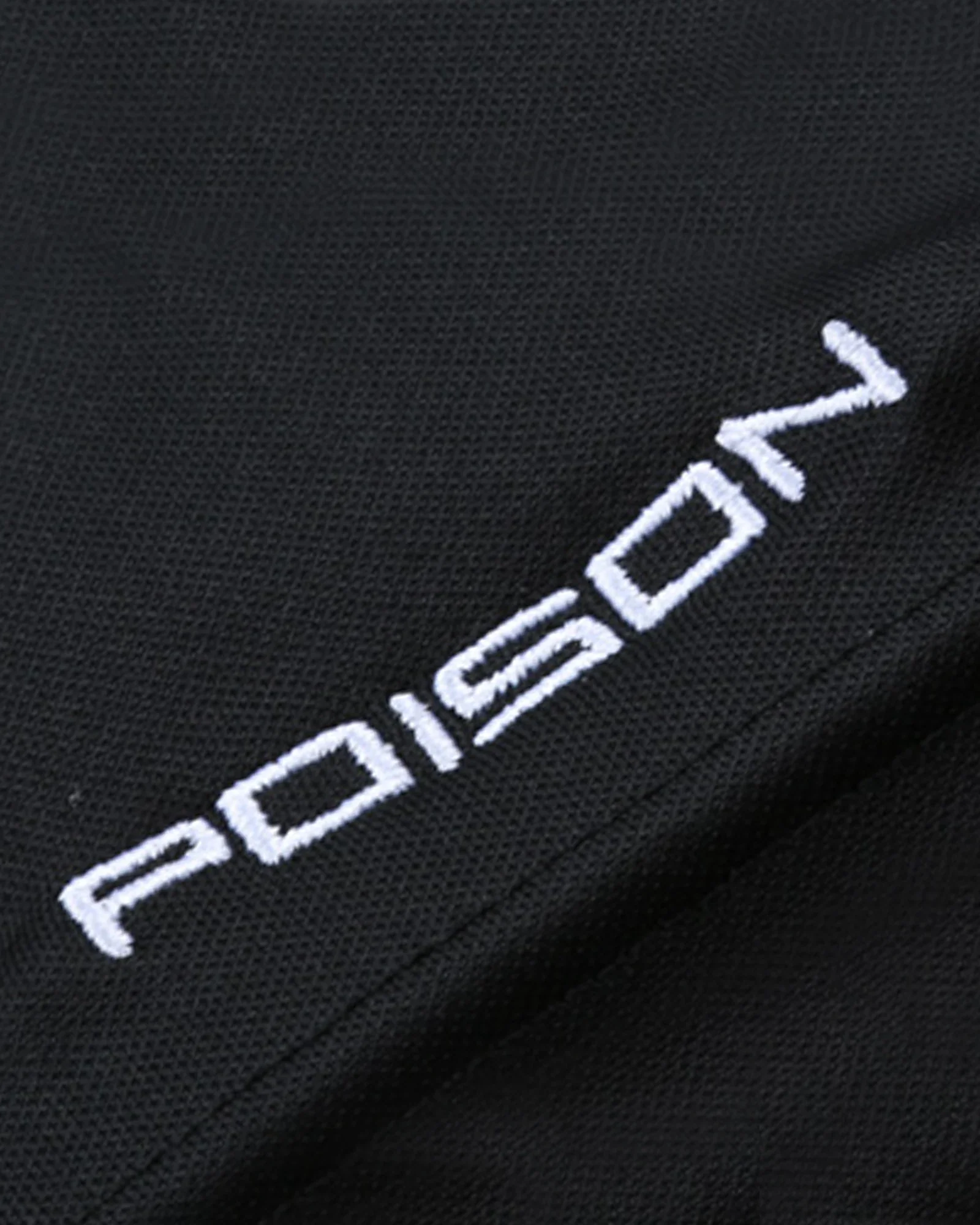White embroidered Poison logo on black fabric background.