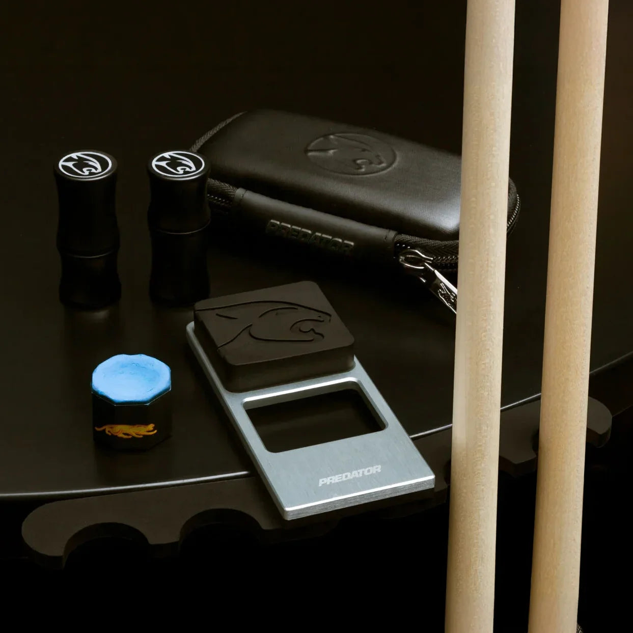 Pool Cues, Joint Protectors, Pure Chalk, and a Case on a Table