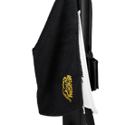 Black towel with yellow embroidered Predator logo, clipped to black and white pool cue case.