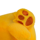 Close-up of a yellow plush toy paw with brown pads