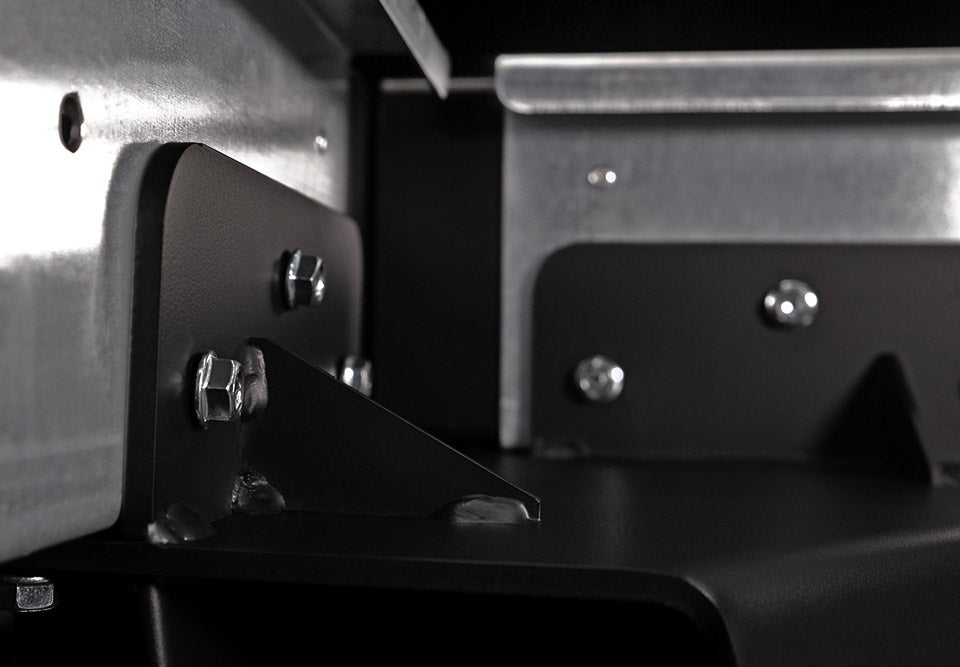 Close-up of metal brackets and screws on a mechanical or industrial component.
