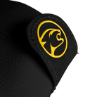 Close-up of black glove material with circular yellow cat head logo on a white background.