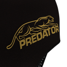 Close-up of black glove material with gold 'Predator' logo on a white background.