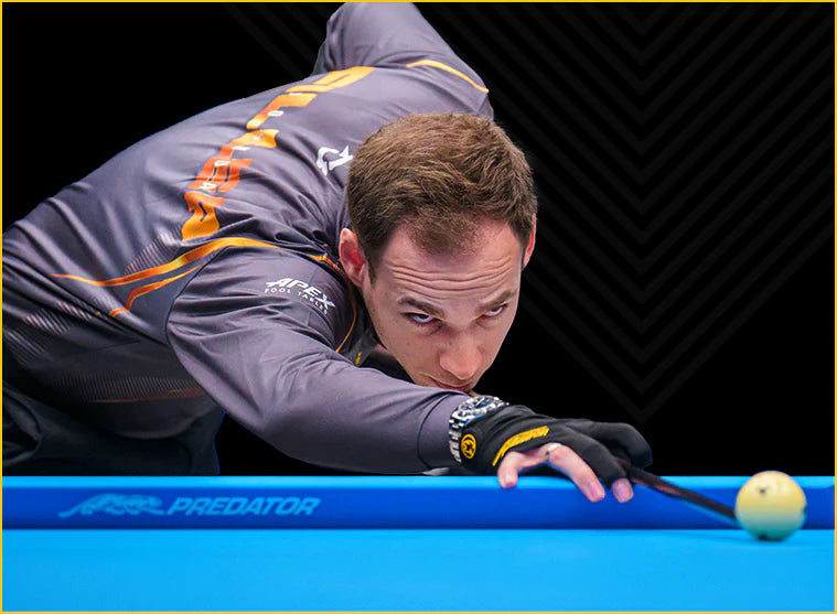 Man hitting a pool cue on a predator arcadia reserve pool table felt cloth