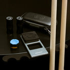 Pool Cues, Joint Protectors, Pure Chalk, and a Case on a Table