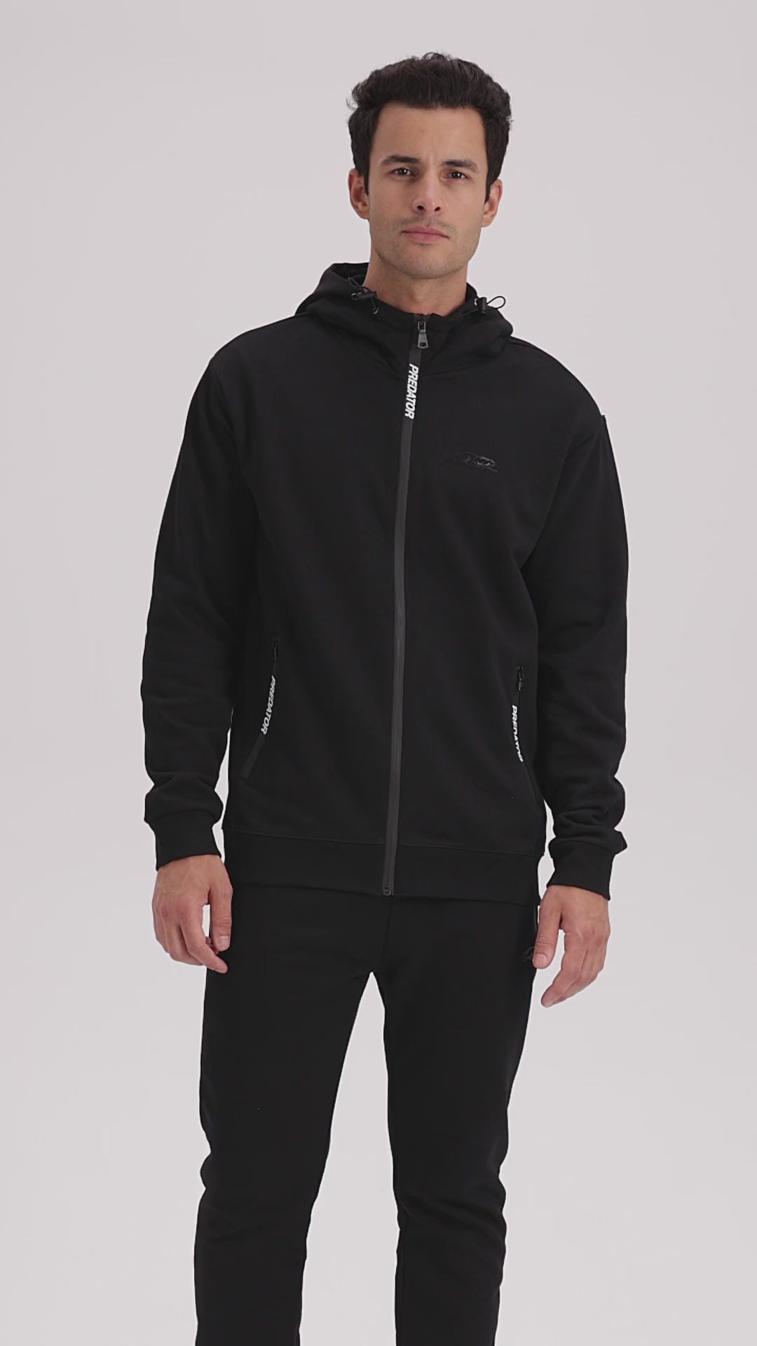 Video of a man wearing black zip up jacket