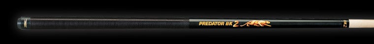 Black pool cue with gold accents and 'Predator' branding